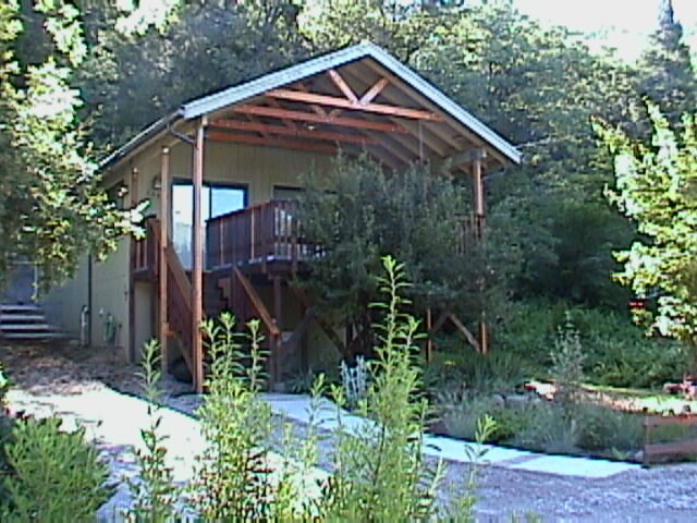 A small house with a porch and a deck.