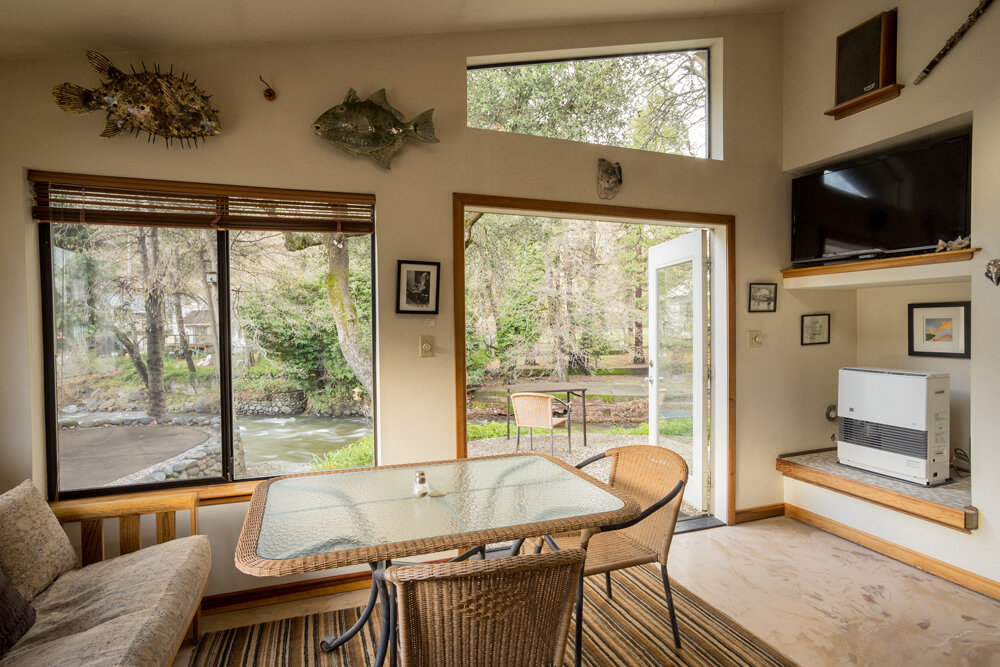 A dining room with a glass table and chairs