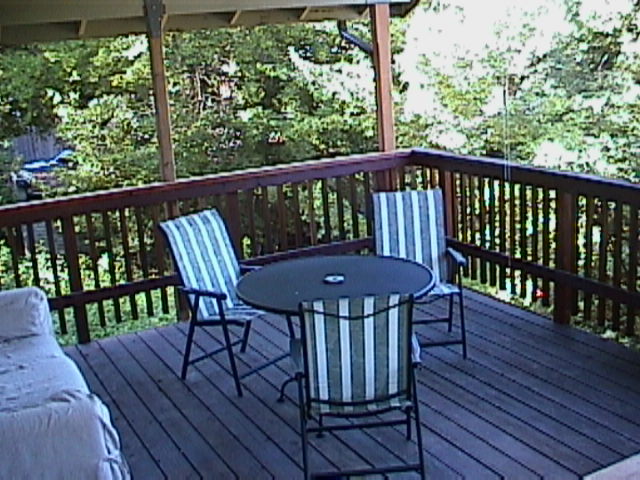 A deck with chairs and table on it