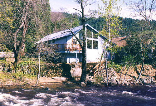 A house sitting on the side of a river.