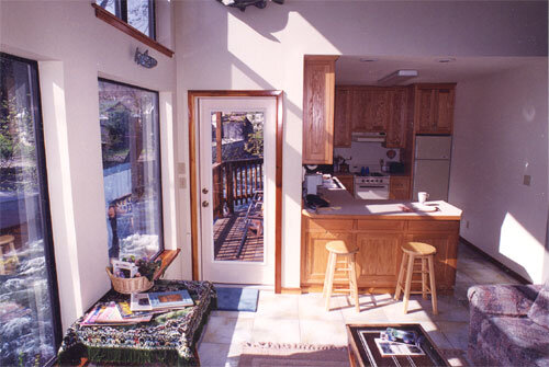 A kitchen with a door open to the living room.