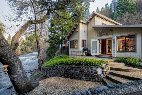 A house with stairs leading to the front of it.