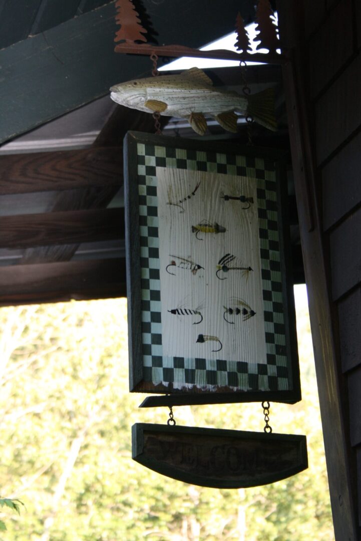 A sign hanging from the ceiling of a house.