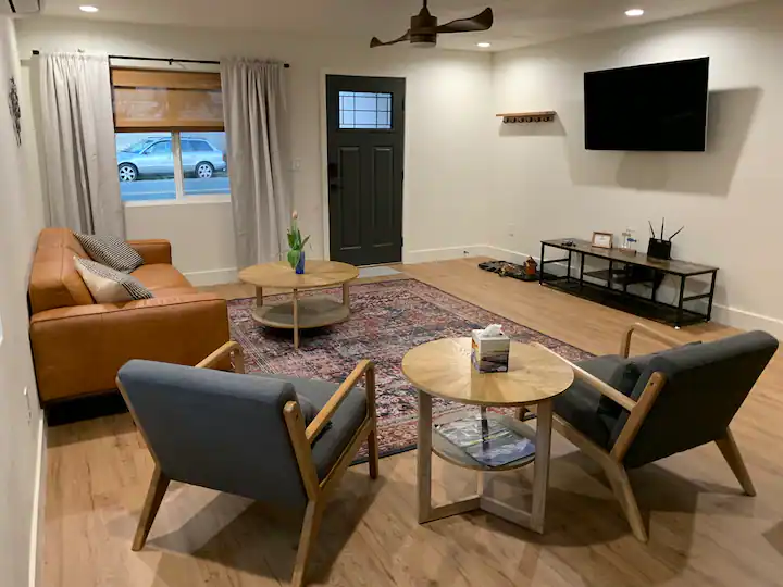 A living room with two chairs and a television.