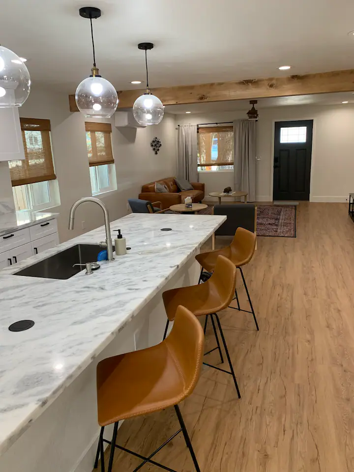 A kitchen with a bar and chairs in it