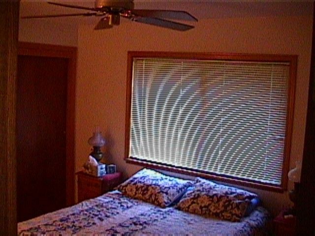 A bedroom with a bed and two pillows.